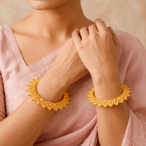 gold plated floral net pattern bangles on woman hand DCC1025